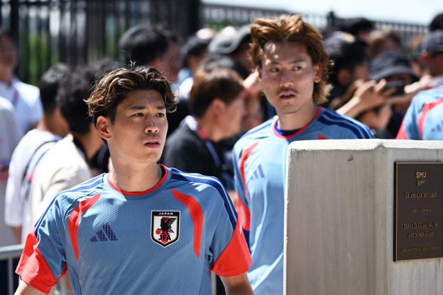 Japan's forward #17 Yuito Suzuki (L) and Japan's defender #20 Ayumu Seko arrive for an MD-1 training session on the eve of the 2026 World Cup Group F football match between the Netherlands and Japan, at the Dallas Stadium in Arlington on June 13, 2026. (Photo by Paul ELLIS / AFP)