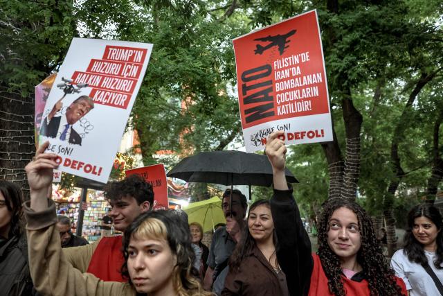 Demonstrators hold placards reading "Don’t disrupt the public’s peace for Trump’s sake" during a rally against the upcoming NATO Summit early July in Ankara, on June 13, 2026. US Secretary of State confirmed the US President would attend the July 7-8 summit in the Turkish capital, as concerns linger about Washington's commitment to the transatlantic alliance. (Photo by Adem ALTAN / AFP)