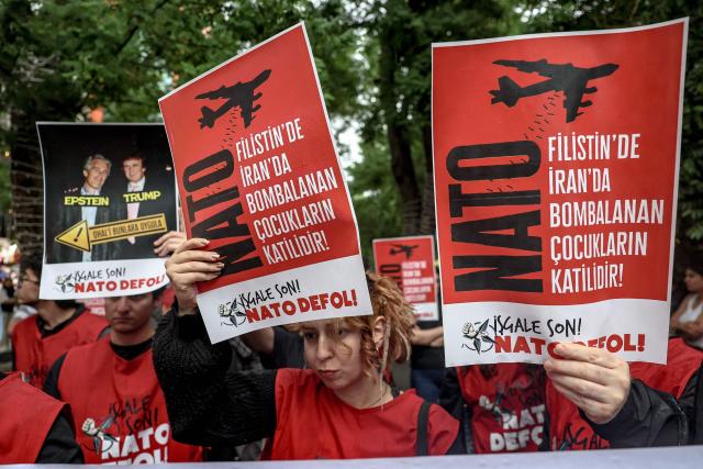 Demonstrators hold placards reading "Don’t disrupt the public’s peace for Trump’s sake" during a rally against the upcoming NATO Summit early July in Ankara, on June 13, 2026. US Secretary of State confirmed the US President would attend the July 7-8 summit in the Turkish capital, as concerns linger about Washington's commitment to the transatlantic alliance. (Photo by Adem ALTAN / AFP)
