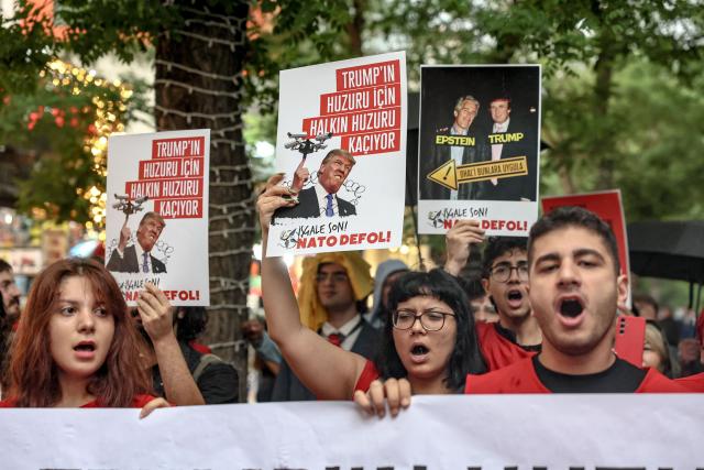 Demonstrators hold placards reading "Don’t disrupt the public’s peace for Trump’s sake" during a rally against the upcoming NATO Summit early July in Ankara, on June 13, 2026. US Secretary of State confirmed the US President would attend the July 7-8 summit in the Turkish capital, as concerns linger about Washington's commitment to the transatlantic alliance. (Photo by Adem ALTAN / AFP)