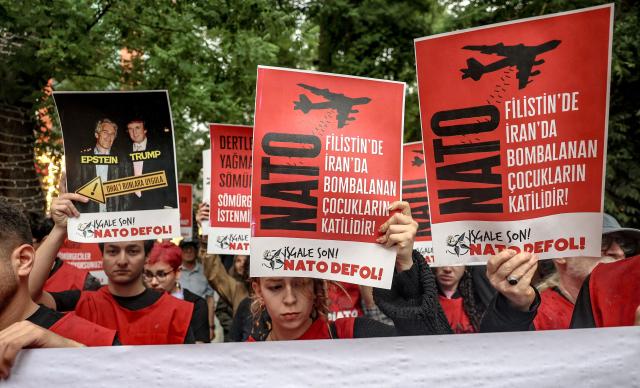 Demonstrators hold placards reading "Don’t disrupt the public’s peace for Trump’s sake" during a rally against the upcoming NATO Summit early July in Ankara, on June 13, 2026. US Secretary of State confirmed the US President would attend the July 7-8 summit in the Turkish capital, as concerns linger about Washington's commitment to the transatlantic alliance. (Photo by Adem ALTAN / AFP)