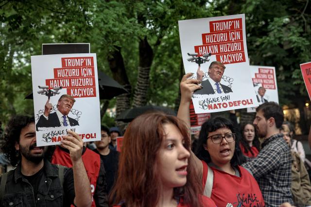 Demonstrators hold placards reading "Don’t disrupt the public’s peace for Trump’s sake" during a rally against the upcoming NATO Summit early July in Ankara, on June 13, 2026. US Secretary of State confirmed the US President would attend the July 7-8 summit in the Turkish capital, as concerns linger about Washington's commitment to the transatlantic alliance. (Photo by Adem ALTAN / AFP)