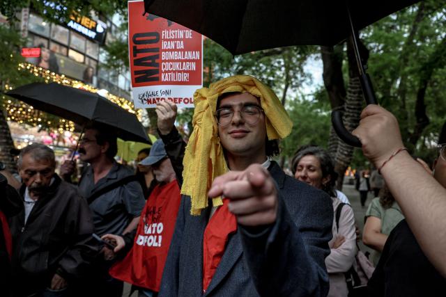 A demonstrator gestures during a rally against the upcoming NATO Summit early July in Ankara, on June 13, 2026. US Secretary of State confirmed the US President would attend the July 7-8 summit in the Turkish capital, as concerns linger about Washington's commitment to the transatlantic alliance. (Photo by Adem ALTAN / AFP)