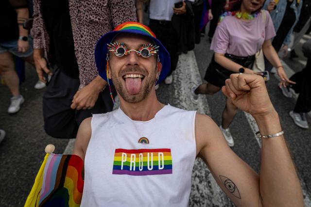 A participant of the Warsaw Pride parade walks celebrates with a Intersex Inclusive Pride Flag in the streets of Warsaw, Poland, on June 13, 2026. (Photo by Wojtek RADWANSKI / AFP)