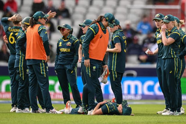 Australia's Ellyse Perry (bottom C) receives medical assistance during the ICC Women's T20 cricket world cup 2026 game between Australia and South Africa, at Old Trafford in Manchester, north-west England on June 13, 2026. (Photo by Oli SCARFF / AFP)