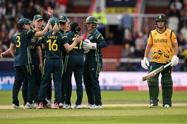 South Africa's Kayla Reyneke (R) walks off after being dismissed by Australia's Alana King (5th L) during the ICC Women's T20 cricket world cup 2026 game between Australia and South Africa, at Old Trafford in Manchester, north-west England on June 13, 2026. (Photo by Oli SCARFF / AFP)