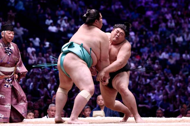 Japanese sumo wrestler Kotozakura (L) battles Japanese sumo wrestler Abi during their semi-final bout on day 1 of the 2026 MUFG Paris Sumo Tournament, in Paris on June 13, 2026. (Photo by Behrouz MEHRI / AFP)