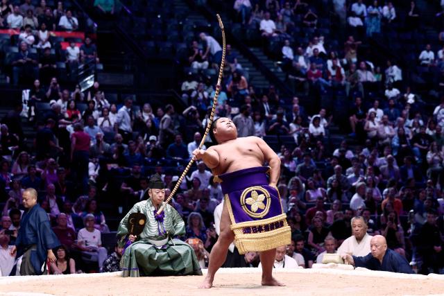 A sumo wrestler performs during the Bow-twirling ceremony (Yumitori-shiki) on day 1 of the 2026 MUFG Paris Sumo Tournament, in Paris on June 13, 2026. (Photo by Behrouz MEHRI / AFP)