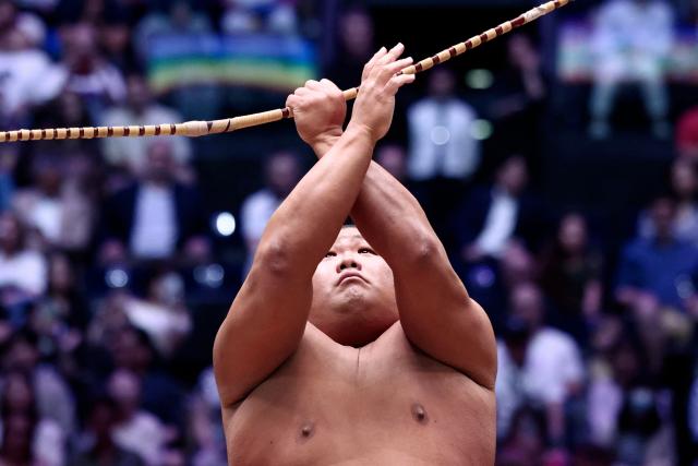 A sumo wrestler performs during the Bow-twirling ceremony (Yumitori-shiki) on day 1 of the 2026 MUFG Paris Sumo Tournament, in Paris on June 13, 2026. (Photo by Behrouz MEHRI / AFP)