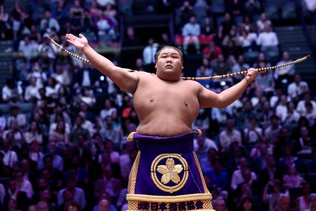 A sumo wrestler performs during the Bow-twirling ceremony (Yumitori-shiki) on day 1 of the 2026 MUFG Paris Sumo Tournament, in Paris on June 13, 2026. (Photo by Behrouz MEHRI / AFP)