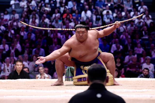 A sumo wrestler performs during the Bow-twirling ceremony (Yumitori-shiki) on day 1 of the 2026 MUFG Paris Sumo Tournament, in Paris on June 13, 2026. (Photo by Behrouz MEHRI / AFP)