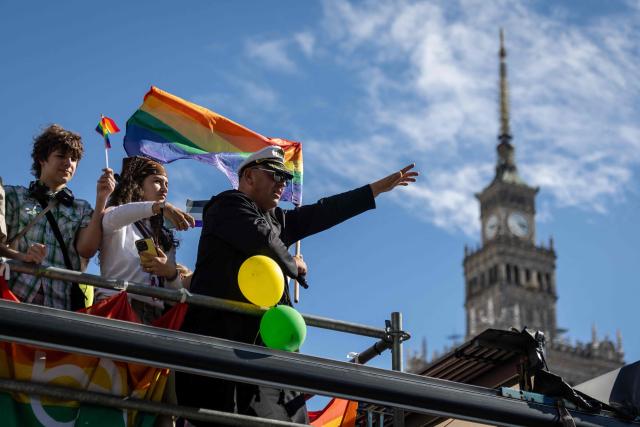 Participants dance on the platform as the pass by the Palace of culture in Warsaw's downtown during the Warsaw Pride parade on June 13, 2026 (Photo by Wojtek RADWANSKI / AFP)