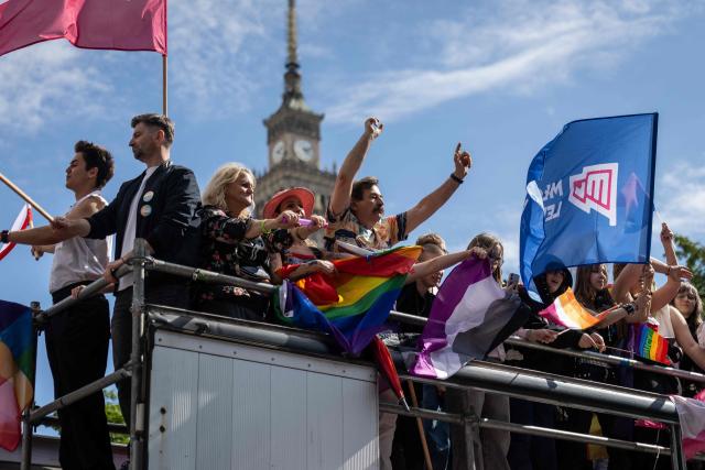 Participants dance on the platform as the pass by the Palace of culture in Warsaw's downtown during the Warsaw Pride parade on June 13, 2026 (Photo by Wojtek RADWANSKI / AFP)