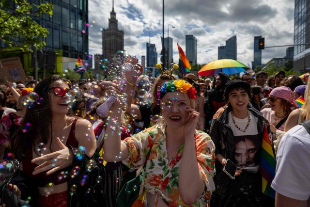 Participants blow soap bubbles as they celebrate during the Warsaw Pride parade on the streets of Warsaw, Poland, on June 13, 2026. (Photo by Wojtek RADWANSKI / AFP)
