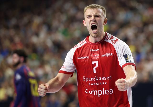 Aalborg's Danish centre back #07 Thomas Sommer Arnoldsen celebrates during the EHF Men's Handball Champions League Final 4 semi-final match between Aalborg Handbold and FC Barcelona in Cologne, western Germany on June 13, 2026. (Photo by Ronny HARTMANN / AFP)