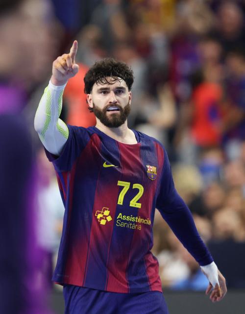 FC Barcelona's French pivot #72 Ludovic Fabregas celebrates during the EHF Men's Handball Champions League Final 4 semi-final match between Aalborg Handbold and FC Barcelona in Cologne, western Germany on June 13, 2026. (Photo by Ronny HARTMANN / AFP)