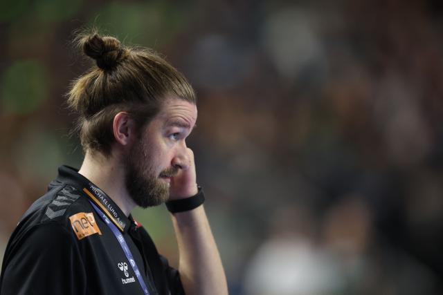 Aalborg's Danish headcoach Simon Dahl Jorgensen reacts during the EHF Men's Handball Champions League Final 4 semi-final match between Aalborg Handbold and FC Barcelona in Cologne, western Germany on June 13, 2026. (Photo by Ronny HARTMANN / AFP)