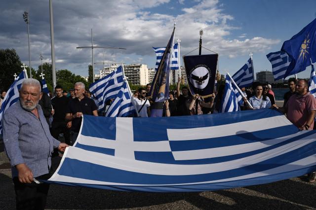 Protestors holding a Greek flag take part in the Family Pride, in Thessaloniki on June 13, 2026. One week before the Thessaloniki pride, members of orthodox and far-right parties parade "for the Greek family consisting of the man, the woman and the children", as they said. (Photo by Sakis Mitrolidis / AFP)