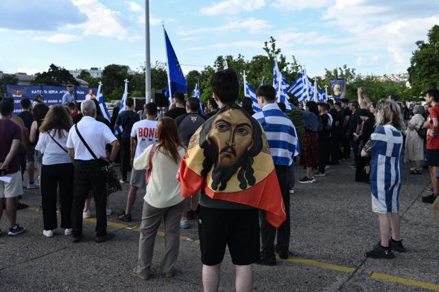 Protestors holding a Greek flag take part in the Family Pride, in Thessaloniki on June 13, 2026. One week before the Thessaloniki pride, members of orthodox and far-right parties parade "for the Greek family consisting of the man, the woman and the children", as they said. (Photo by Sakis Mitrolidis / AFP)