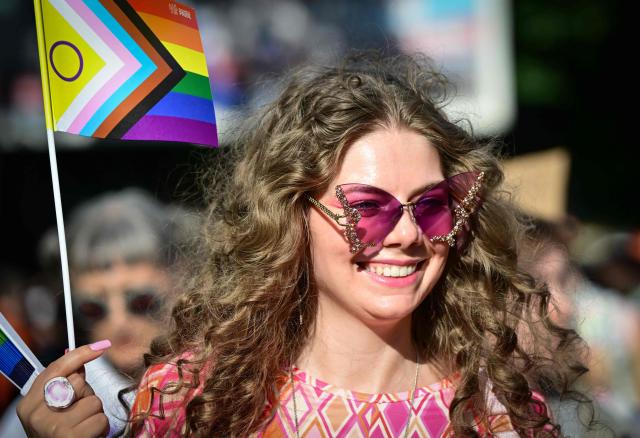 A participant holds a  Intersex Inclusive Pride Flag during the Bucharest Pride march in Bucharest June 13, 2026. Tens of thousands of participants march with rainbow flags down Calea Victoriei during the 21st annual Bucharest Pride march, demanding equal rights and legal recognition for same-sex couples in Romania. (Photo by Daniel MIHAILESCU / AFP)