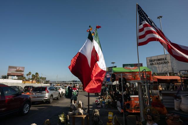 A street vendor sells Mexican jerseys and flags to people crossing to the United States at the San Ysidro border crossing on the Mexican side of the border in Tijuana on June 13, 2026. (Photo by Guillermo Arias / AFP)