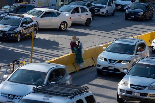 A street vendor sells Mexican jerseys and flags to people crossing to the United States at the San Ysidro border crossing on the Mexican side of the border in Tijuana on June 13, 2026. (Photo by Guillermo Arias / AFP)