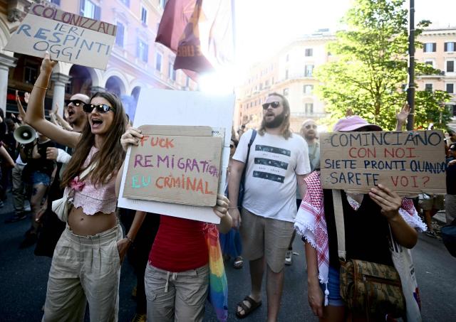 Anti-fascist demonstrators hold placards against remigration as they march against a rally organised by right-wing groups advocating "remigration", in Rome on June 13, 2026. (Photo by Filippo MONTEFORTE / AFP)