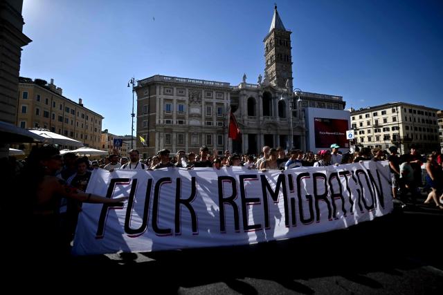 Anti-fascist demonstrators hold a banner against remigration during a protest organised by right-wing groups to call for the repatriation of migrants, in Rome on June 13, 2026. (Photo by Filippo MONTEFORTE / AFP)