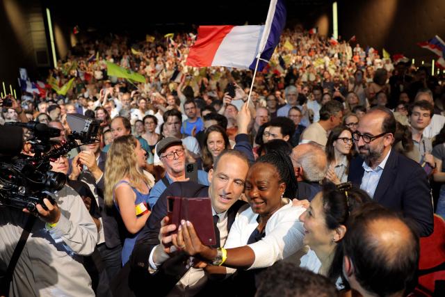 French centre-left party Place publique leader and presidential candidate Raphael Glucksmann (L) poses for a photograph with a supporter as he arrives to address a political rally ahead of the April 2027 French presidential election in Aubervilliers, a northern suburb of Paris, on June 13, 2026. (Photo by Kenzo TRIBOUILLARD / AFP)