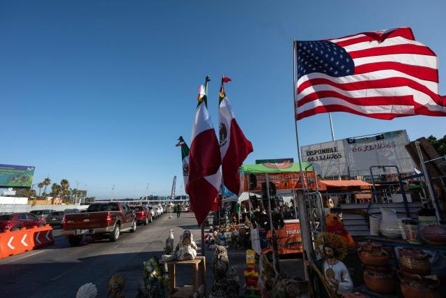 Street vendors sell Mexican jerseys to people  to people crossing to the United States at the San Ysidro border crossing on the Mexican side of the border in Tijuana on June 13, 2026. (Photo by Guillermo Arias / AFP)