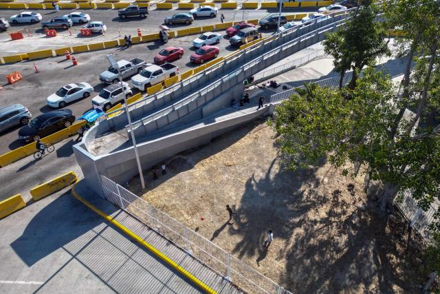 Aerial view of children playing football at the San Ysidro crossing port on the Mexican side of the border in Tijuana, on June 13, 2026. (Photo by Guillermo Arias / AFP)