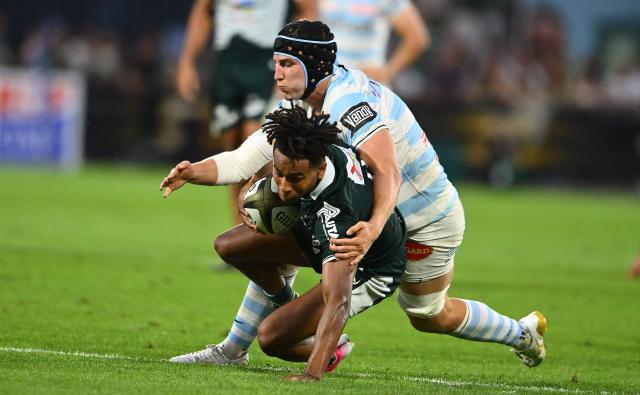 Pau's French wing Théo Attissogbe is tackled during the French Top14 rugby union playoff match between Section Paloise Bearn Pyrenees (Pau) and Racing 92 at Stade du Hameau in Pau, south-western France on June 13, 2026. (Photo by Gaizka IROZ / AFP)