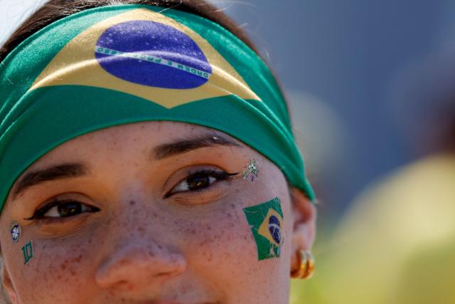 A fan of Brazil looks on as people gather ahead of a watch party for the 2026 World Cup football tournament match between Brazil and Morocco, at the FIFA Fan Zone in the Brooklyn borough of New York City, on June 13, 2026. (Photo by Leonardo MUNOZ / AFP)