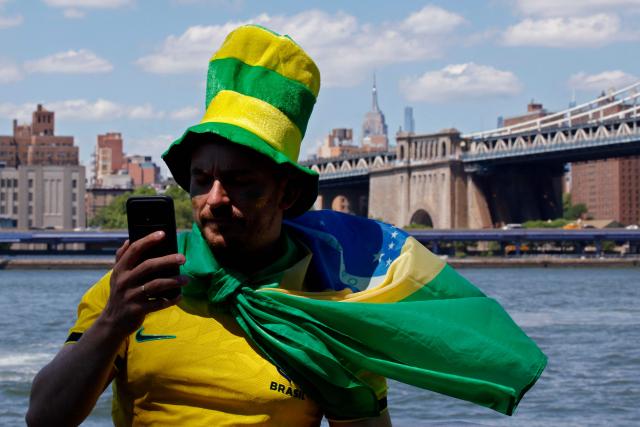 A fan of Brazil takes a selfie as people gather ahead of a watch party for the 2026 World Cup football tournament match between Brazil and Morocco, at the FIFA Fan Zone in the Brooklyn borough of New York City, on June 13, 2026. (Photo by Leonardo MUNOZ / AFP)