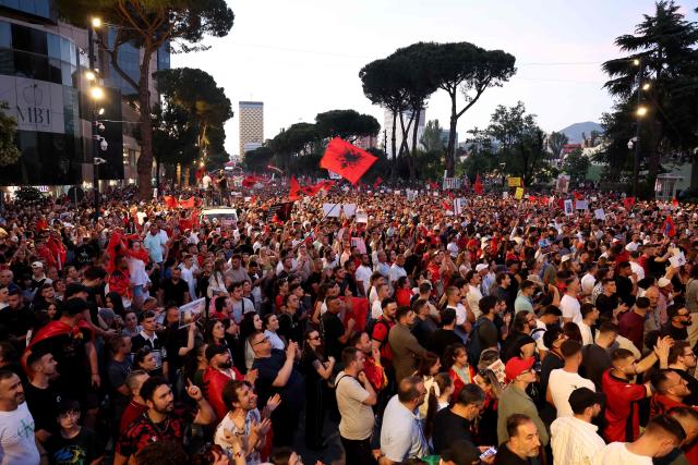 Protestors hold national flags as they gather in front of Albania's Prime Minister's Office, in Tirana, on June 13, 2026 during a demonstration against the construction of a luxury resort near a protected natural area of Zvernec near Vlore. Several thousand citizens demonstrated in Tirana, 14 days in row after the first protest  repressed on Zvernec beach, to demand transparency around a tourist complex project allegedly linked to US President's son-in-law, Jared Kushner. The demonstrators argue that the estimated $1.2 billion project, led by Kushner and his wife Ivanka, will harm the environment, with plans for luxury hotels in the protected area of Vjosa-Narta on the southern coast. (Photo by Adnan Beci / AFP)
