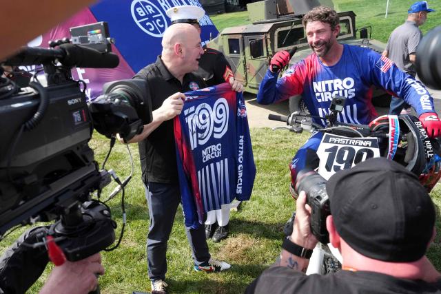 UFC President and CEO Dana White (L) holds the jersey of Travis Pastrana alongside Pastrana (R) following a motorcycle jump performance, ahead of Sunday's UFC Freedom 250 fights on the South Lawn of the White House in Washington, DC, on June 13, 2026. (Photo by Alex Brandon / POOL / AFP)
