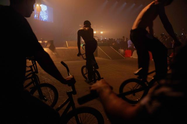 Young men perform bike tricks during "BRUDNY PES" (dirty dog), a multi-genre music festival independent music and street culture, at the Dovzhenko Film Studio in Kyiv on June 13, 2026, amid the Russian invasion of Ukraine. The festival will raffle off a car for donations in support of the Armed Forces of Ukraine. All funds raised will go toward purchasing drones. Since 2023, the festival has partnered with the "Khvostati" animal shelter, selecting a new dog each year to serve as the festivals mascot. Its photo is featured on the main poster, and seeks to find it a home. (Photo by Tetiana DZHAFAROVA / AFP)