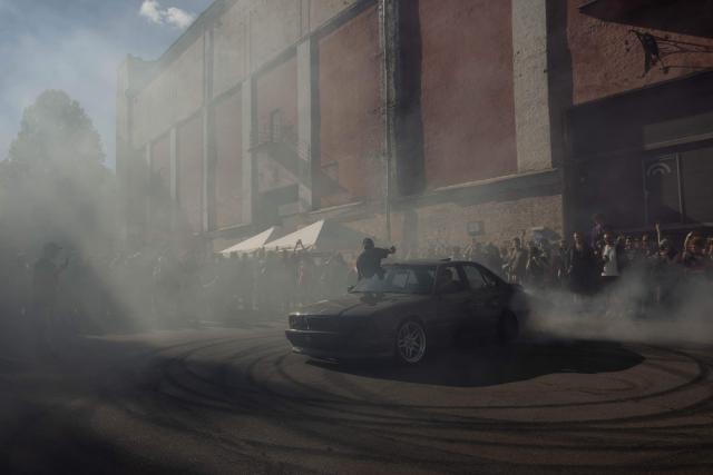 A driver drifts in a car during "BRUDNY PES" (dirty dog), a multi-genre music festival independent music and street culture, at the Dovzhenko Film Studio in Kyiv on June 13, 2026, amid the Russian invasion of Ukraine. The festival will raffle off a car for donations in support of the Armed Forces of Ukraine. All funds raised will go toward purchasing drones. Since 2023, the festival has partnered with the "Khvostati" animal shelter, selecting a new dog each year to serve as the festivals mascot. Its photo is featured on the main poster, and seeks to find it a home. (Photo by Tetiana DZHAFAROVA / AFP)