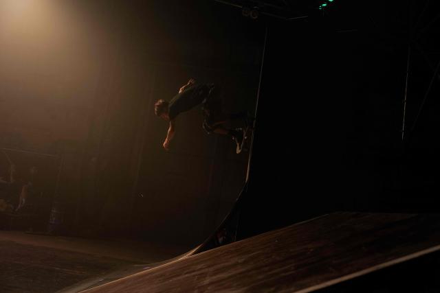 A young man performs skate tricks during "BRUDNY PES" (dirty dog), a multi-genre music festival independent music and street culture, at the Dovzhenko Film Studio in Kyiv on June 13, 2026, amid the Russian invasion of Ukraine. The festival will raffle off a car for donations in support of the Armed Forces of Ukraine. All funds raised will go toward purchasing drones. Since 2023, the festival has partnered with the "Khvostati" animal shelter, selecting a new dog each year to serve as the festivals mascot. Its photo is featured on the main poster, and seeks to find it a home. (Photo by Tetiana DZHAFAROVA / AFP)
