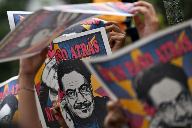 Supporters of Colombia's presidential candidate for the Pacto Historico party, Ivan Cepeda, hold posters of him during the closing rally of his campaign in Bogota on June 13, 2026. Colombia will hold the runoff presidential election on June 21. (Photo by Juan BARRETO / AFP)
