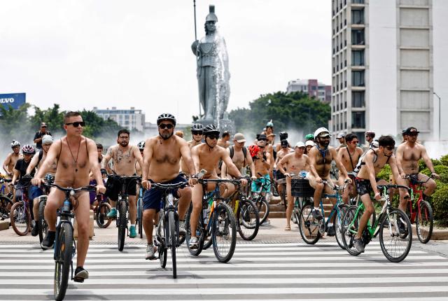 EDITORS NOTE: Graphic content / Cyclists participate in the 2026 World Naked Bike Ride, with the "Minerva" sculpture in the background, in Guadalajara, Jalisco state, Mexico, on June 13, 2026. (Photo by ULISES RUIZ / AFP)