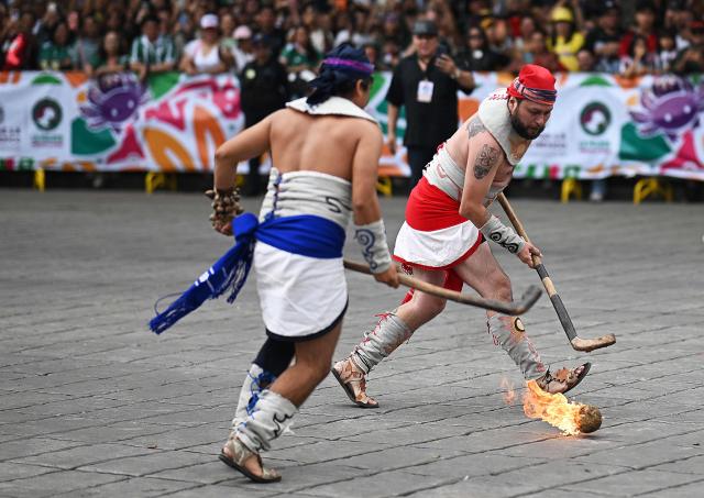 Performers play 'Pelota purepecha', an ancient Indigenous sport, during the World Cup parade in Mexico City on June 13, 2026. (Photo by CARL DE SOUZA / AFP)