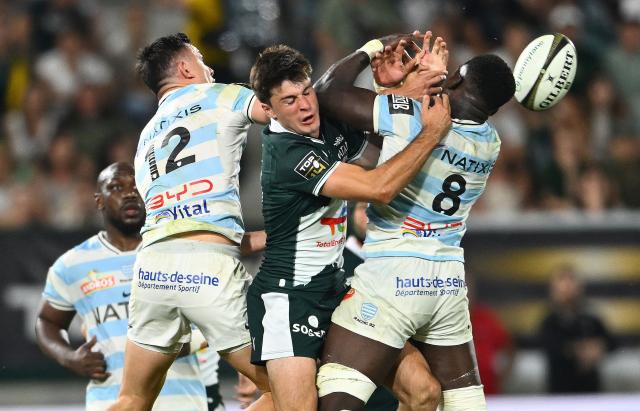 (From L) Racing 92' New Zaeland center Joseph Manu, Pau's French fly-half Axel Desperes and Racing 92' Zimbabwean flanker Shingirai Manyarara jump to grab the ball during the French Top14 rugby union playoff match between Section Paloise Bearn Pyrenees (Pau) and Racing 92 at Stade du Hameau in Pau, south-western France on June 13, 2026. (Photo by Gaizka IROZ / AFP)