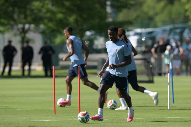 England's defender #06 Marc Guehi  plays with a ball during a training session ahead of England's 2026 World Cup football tournament Group L football match against Croatia at Swope Soccer Village in Kansas City on June 13, 2026.  (Photo by JUAN MABROMATA / AFP)