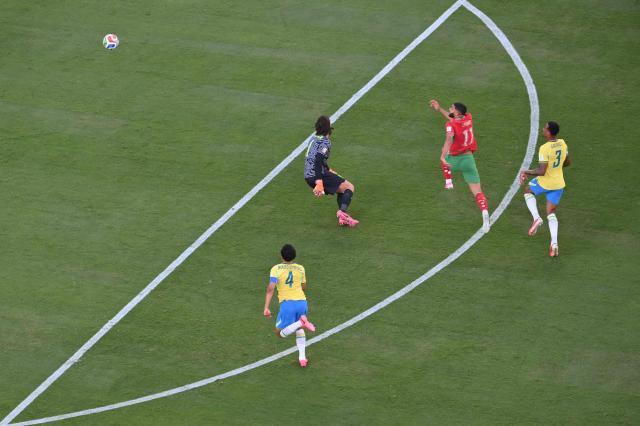 Morocco's midfielder #11 Ismael Saibari (C) scores his team's first goal during the 2026 World Cup Group C football match between Brazil and Morocco at the New York/New Jersey Stadium in East Rutherford on June 13, 2026. (Photo by Angela WEISS / AFP)