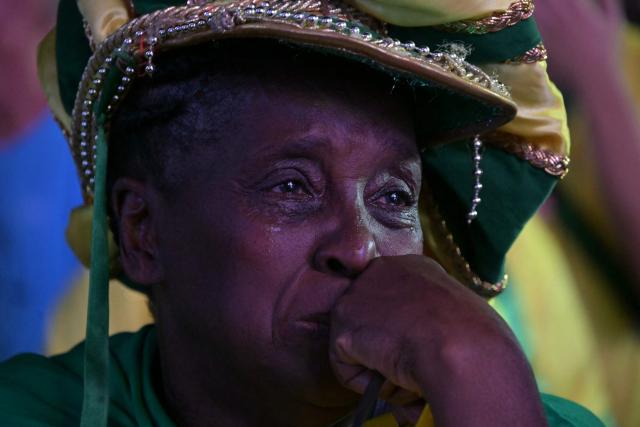 A Brazilian fan cries while watching the live broadcast of the 2026 World Cup football match between Brazil and Morocco at the Copacabana Arena in Rio de Janeiro, Brazil, on June 13 2026. (Photo by NELSON ALMEIDA / AFP)