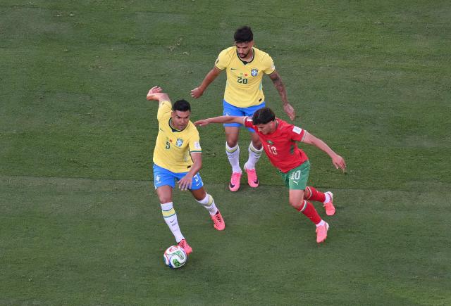 Brazil's midfielder #05 Casemiro (L) and Morocco's forward #10 Brahim Diaz (R) fight for the ball during the 2026 World Cup Group C football match between Brazil and Morocco at the New York/New Jersey Stadium in East Rutherford on June 13, 2026. (Photo by Angela WEISS / AFP)