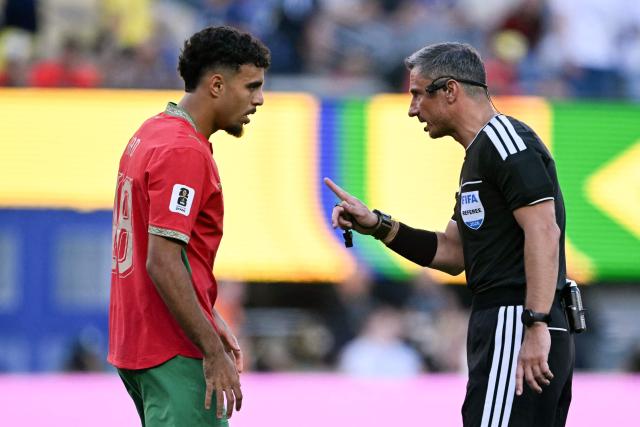 Slovene referee Slavko Vincic speaks to Morocco's defender #18 Chadi Riad during the 2026 World Cup Group C football match between Brazil and Morocco at the New York/New Jersey Stadium in East Rutherford on June 13, 2026. (Photo by MAURO PIMENTEL / AFP)
