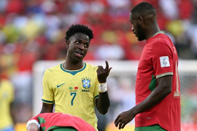 Brazil's forward #07 Vinicius Junior speaks to Morocco's defender #14 Issa Diop during the 2026 World Cup Group C football match between Brazil and Morocco at the New York/New Jersey Stadium in East Rutherford on June 13, 2026. (Photo by MAURO PIMENTEL / AFP)