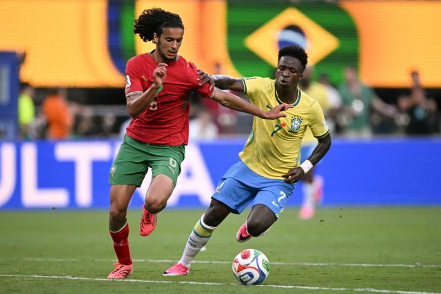 Morocco's midfielder #06 Ayyoub Bouaddi and Brazil's forward #07 Vinicius Junior fight for the ball during the 2026 World Cup Group C football match between Brazil and Morocco at the New York/New Jersey Stadium in East Rutherford on June 13, 2026. (Photo by Mauro PIMENTEL / AFP)